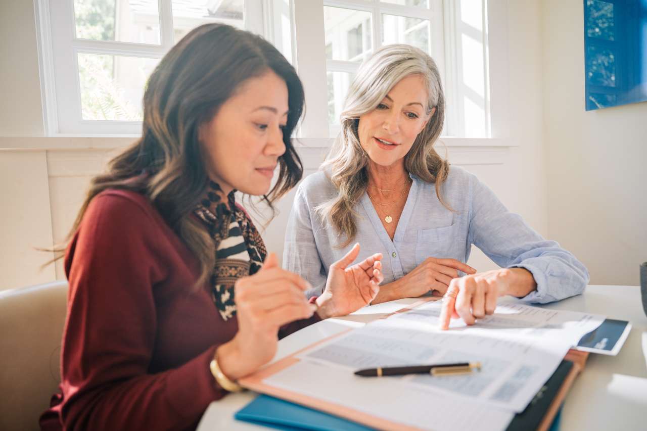 two women reviewing docs