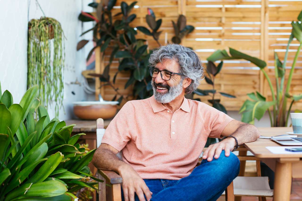 Man sitting in chair laughing