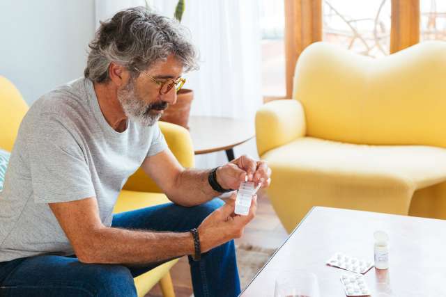 Middle-aged man sorting pills